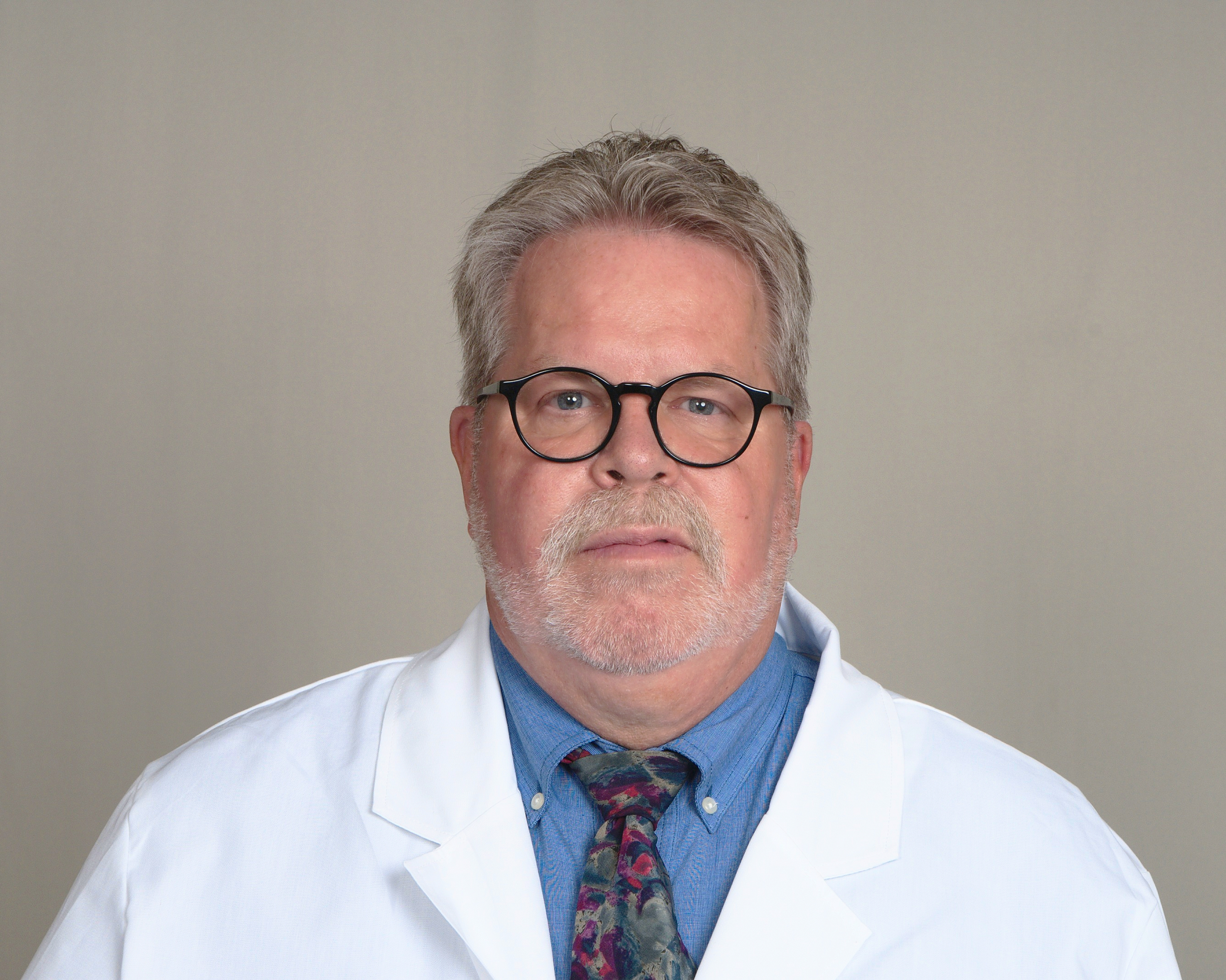 Headshot of Verne Mounts, a registered pharmacist with Express Scripts® Pharmacy, in his lab coat.